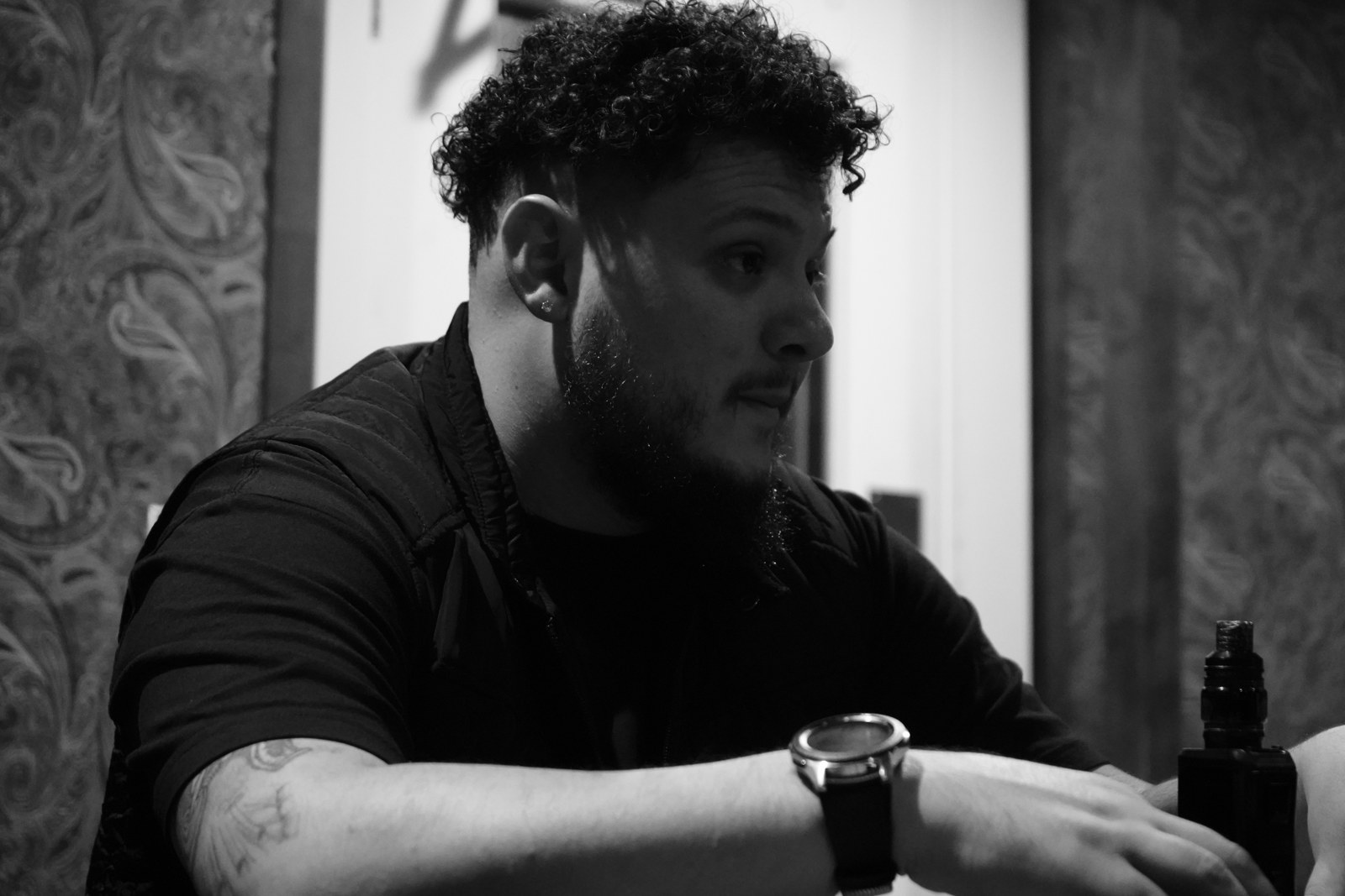 Black and white portrait of Aveek at a table